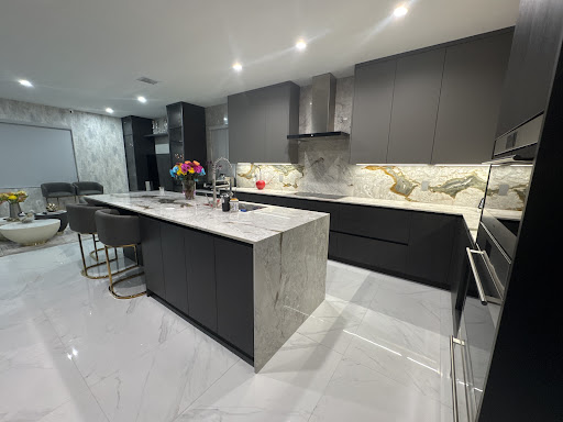 Italkraft dark kitchen with marble waterfall island